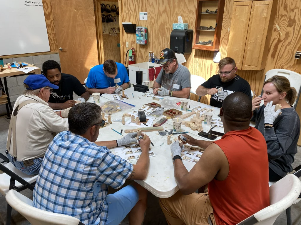 Veterans participating in a hands-on art workshop during Veterans Appreciation Day at Eureka Springs School of the Arts in Arkansas