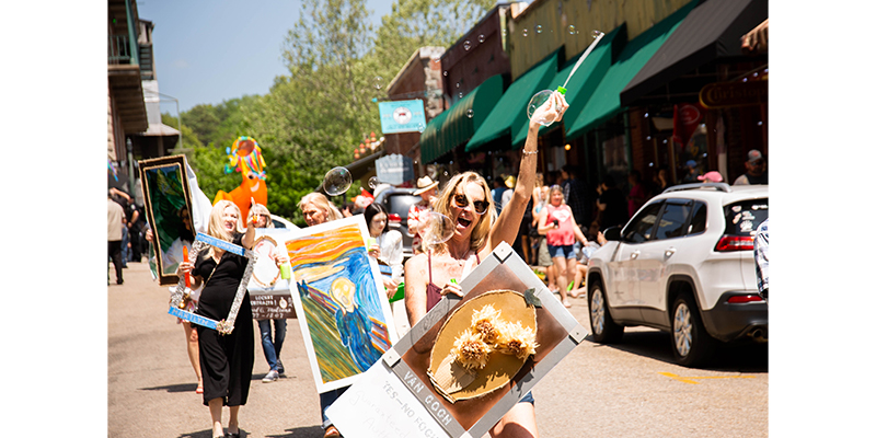Parade Goers Holding Various Famous Paintings in Eureka Springs ArtRageous Parade