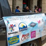 A thank you banner is displayed from the side of a truck to the ARTrageous Parade 2024 sponsors