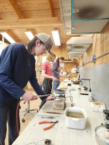 Students learning metalsmithing techniques during an ESSA Young Artist Program workshop in ESSA’s studios