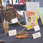 Close-up of donated artwork and handmade items displayed for the Hands On ESSA art auction