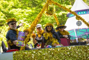 Participants dressed in disco-themed costumes during the ArtRageous Parade in Eureka Springs