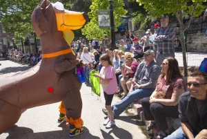 Inflatable dog costume entertains families during the ArtRageous Parade in Eureka Springs Arkansas