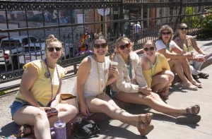 Young spectators sit along the parade route during the ArtRageous Parade in Eureka Springs
