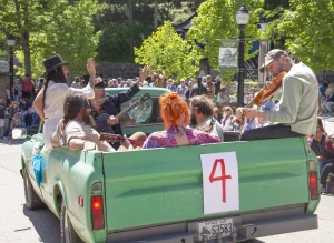 Musicians perform from a vintage pickup truck during the ArtRageous Parade in Eureka Springs, Arkansas