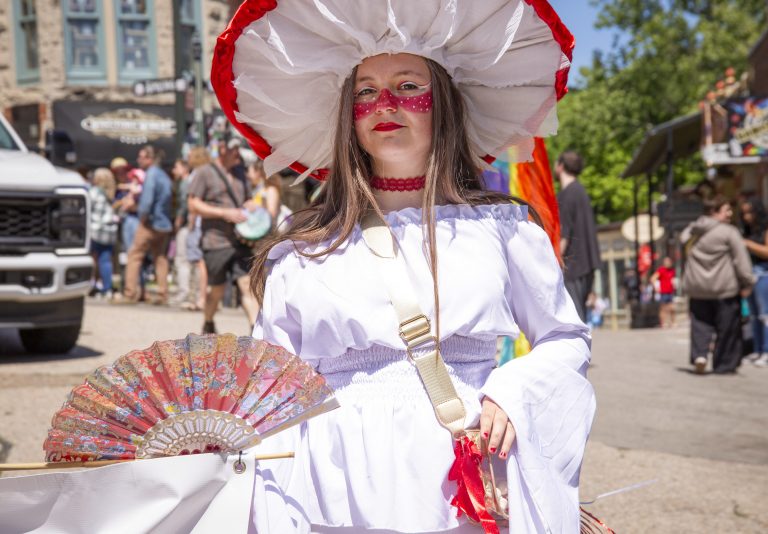 Parade participant in a whimsical mushroom-inspired costume during the ArtRageous Parade in Eureka Springs, Arkansas