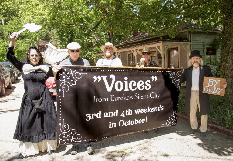Participants carrying a “Voices from Eureka’s Silent City” banner during the ArtRageous Parade in Eureka Springs, Arkansas
