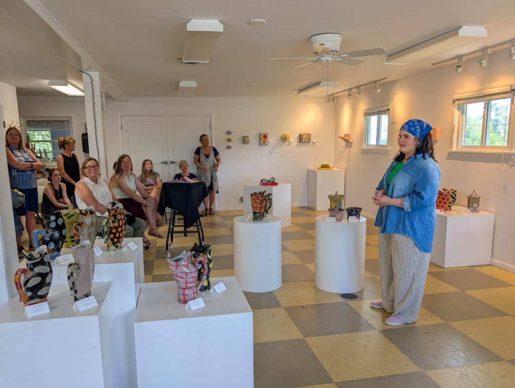 Erin Harris speaks to guests and answers questions during the Artists-in-Residence Reception at ESSA.