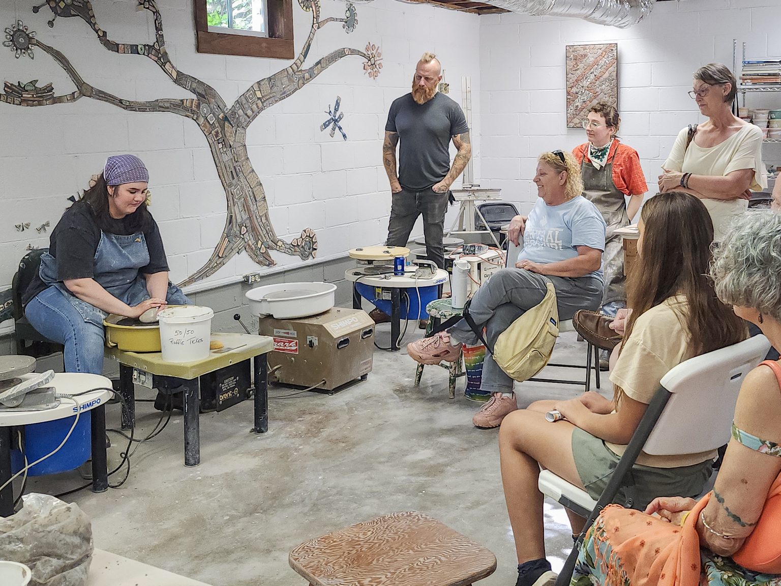 Erin Harris demonstrates wheel-throwing for visitors during ESSA’s Summer Studio Stroll.