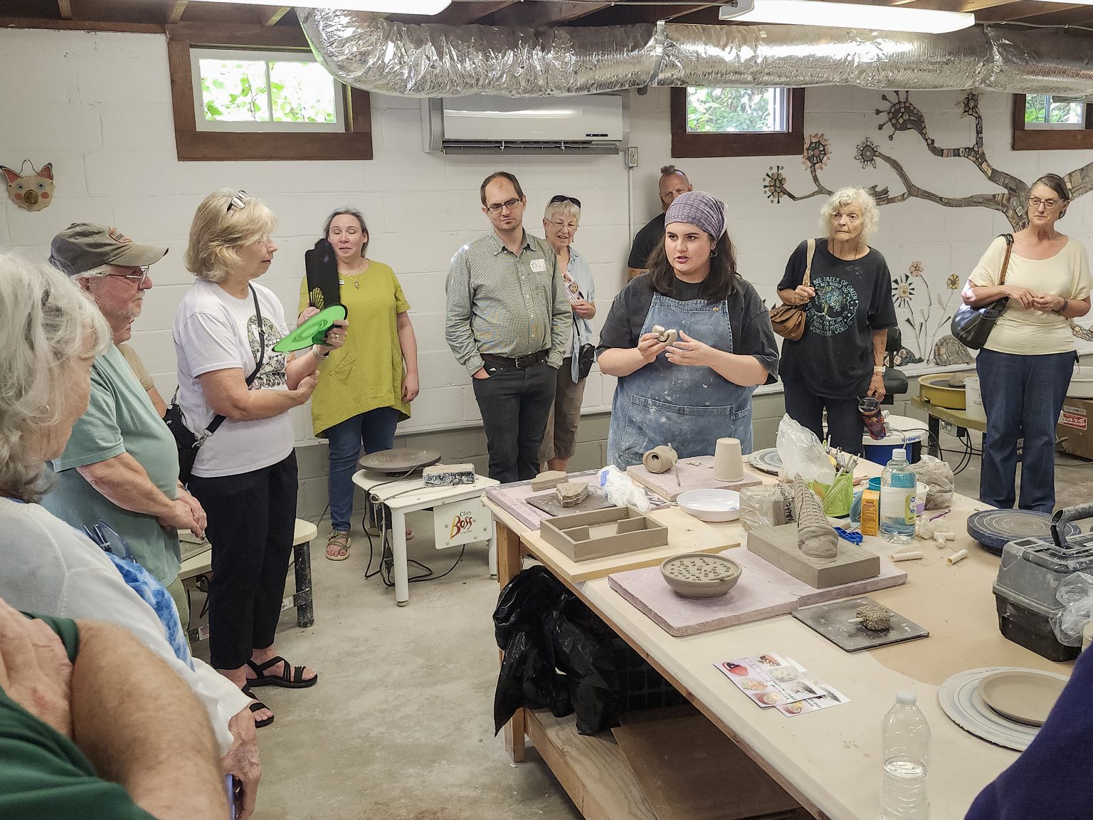 Erin Harris discusses her ceramic process with visitors gathered in the ESSA Ceramics Studio.
