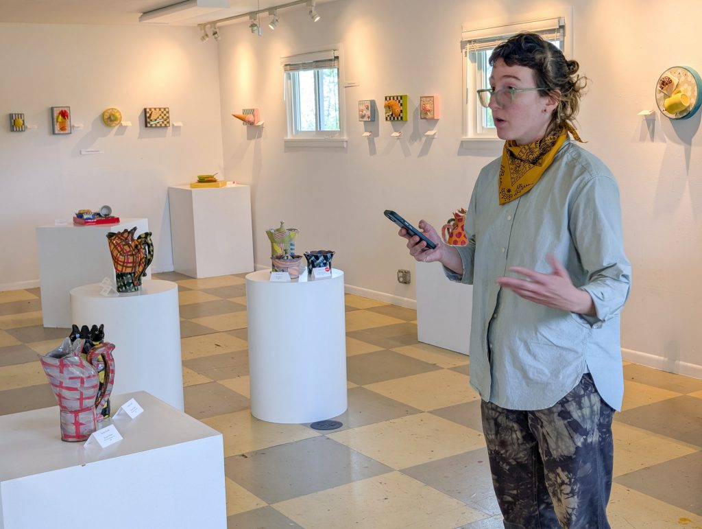Kaitlyn Cirielli speaks during the Artist Q&A with ceramic work displayed throughout the ESSA gallery.