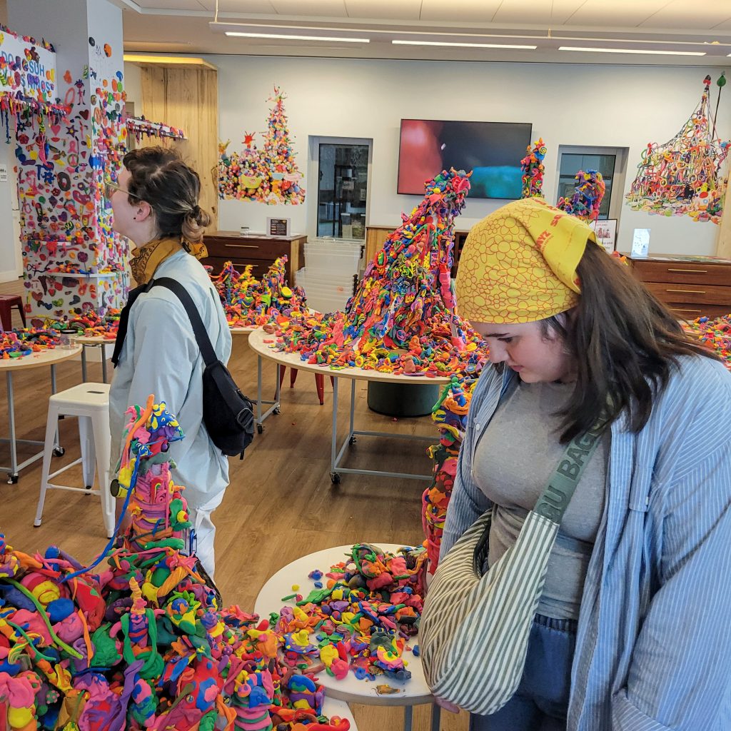 Kaitlyn Cirielli and Erin Harris view colorful clay sculptures in Do Ho Suh and Children: Artland at Crystal Bridges.