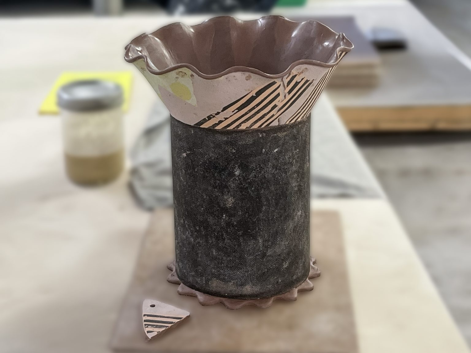 Unfired ceramic vessel supported by a cylindrical tarpaper form during Kaitlyn Cirielli’s construction process.