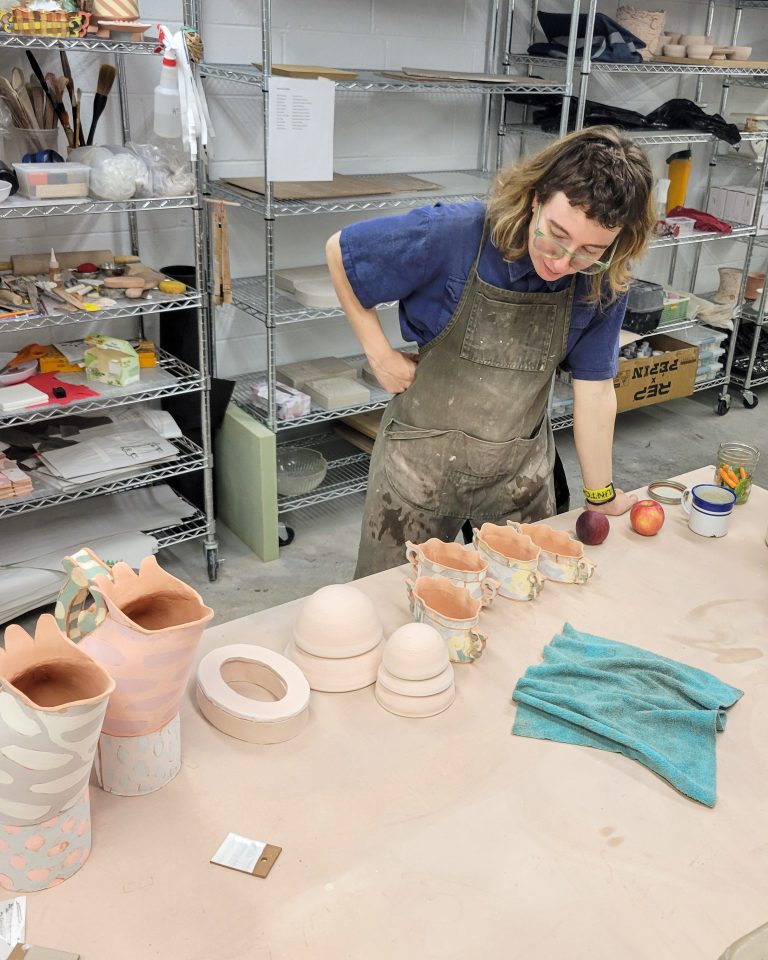 Ceramic artist Kaitlyn Cirielli works among vessels and molds in the ESSA Ceramics Studio during her 2026 residency.