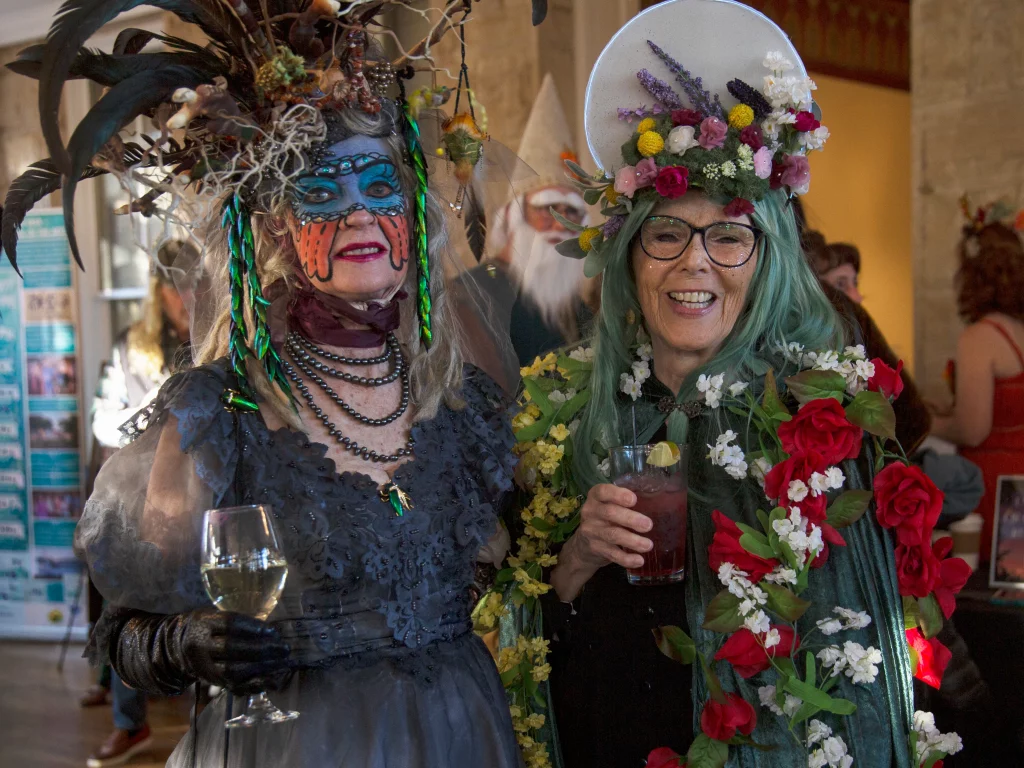 Guests in elaborate costumes and hats at ESSA's Mad Hatter Ball