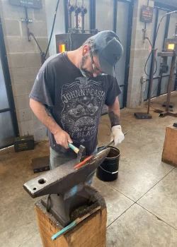 Veteran participating in a blacksmithing workshop at Eureka Springs School of the Arts during Veterans Appreciation Day